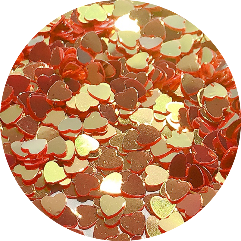 Paillettes cœurs rouges aux reflets dorés