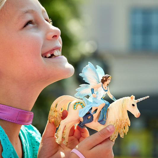 Eyela chevauchant une licorne dorée