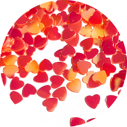 Paillettes cœurs rouges aux reflets dorés